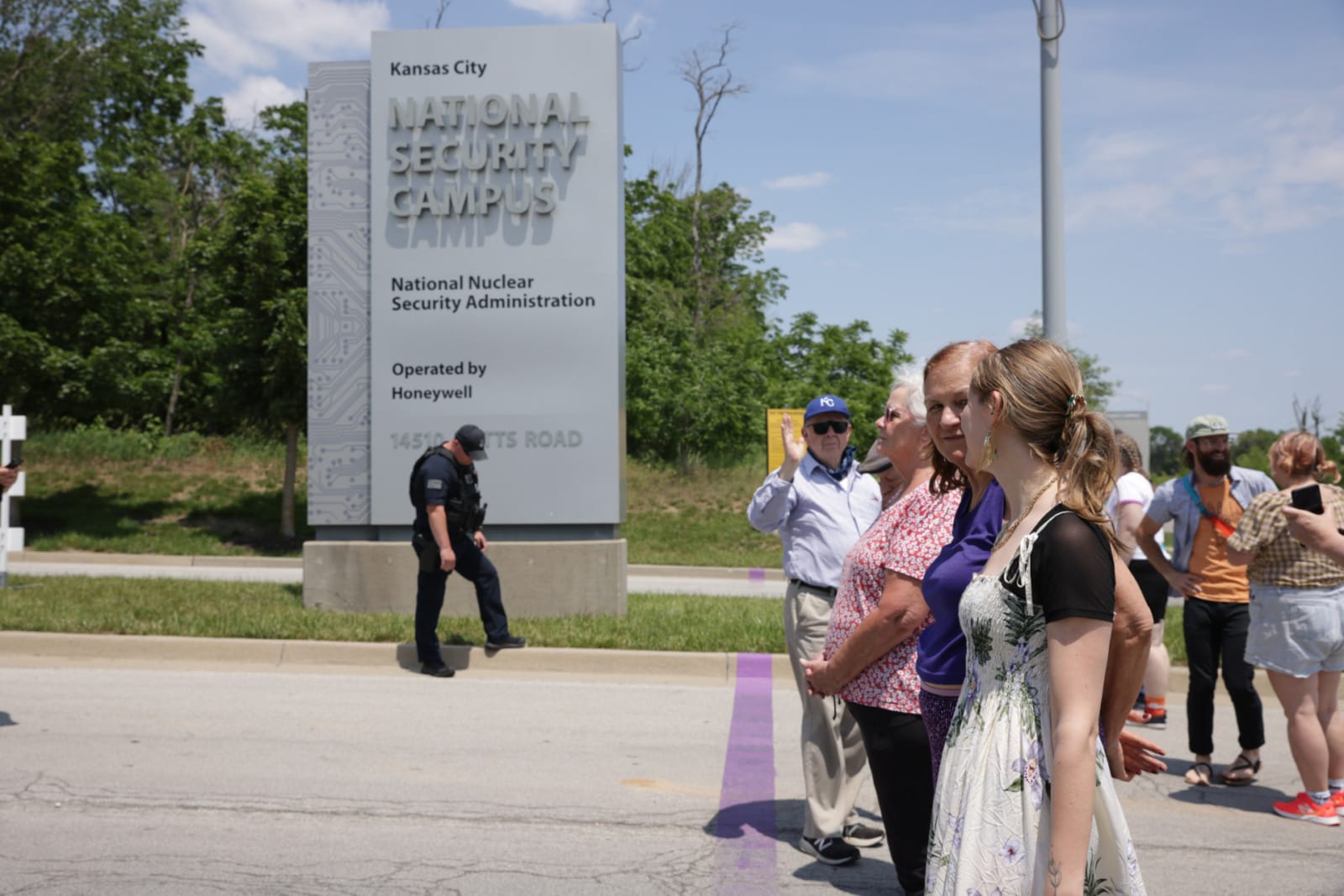Suellentrop and members of PeaceWorks KC stand at the property line at the National Security Campus.