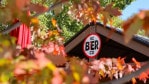 KC Bier Co. sign among colorful fall leaves.