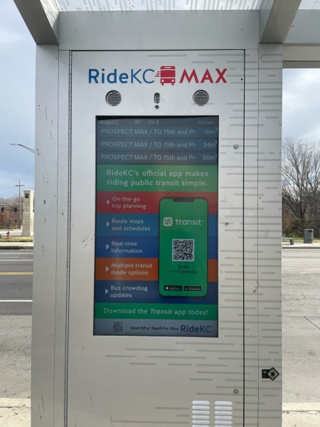 A sign at the bus stop touts RideKC's app.