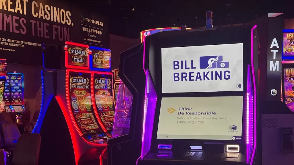 An ad for the gambling helpline shows up on the bill breaking machine inside Hollywood Casino in Kansas City, Kansas.