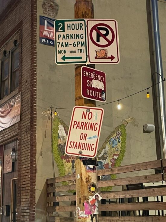 A jumbled combination of parking signs in the East Crossroads.