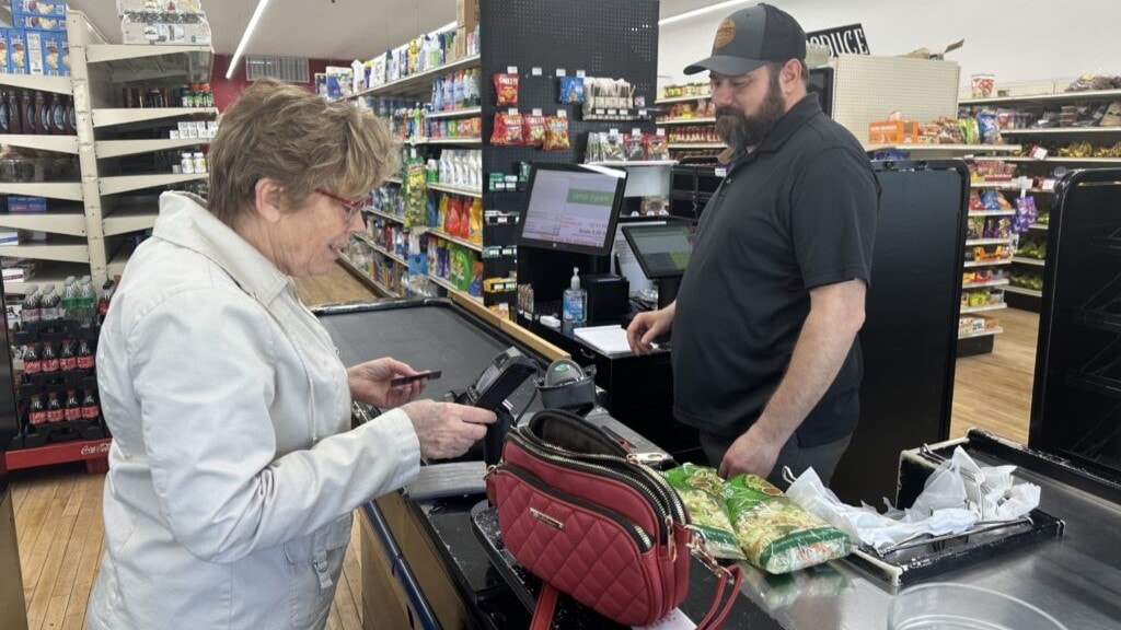 Brian Horak rings up Corliss Hassler at Post 60 Market in Emerson, Neb. Hassler is a regular customer and investor in the cooperative grocery store, which opened in 2022.