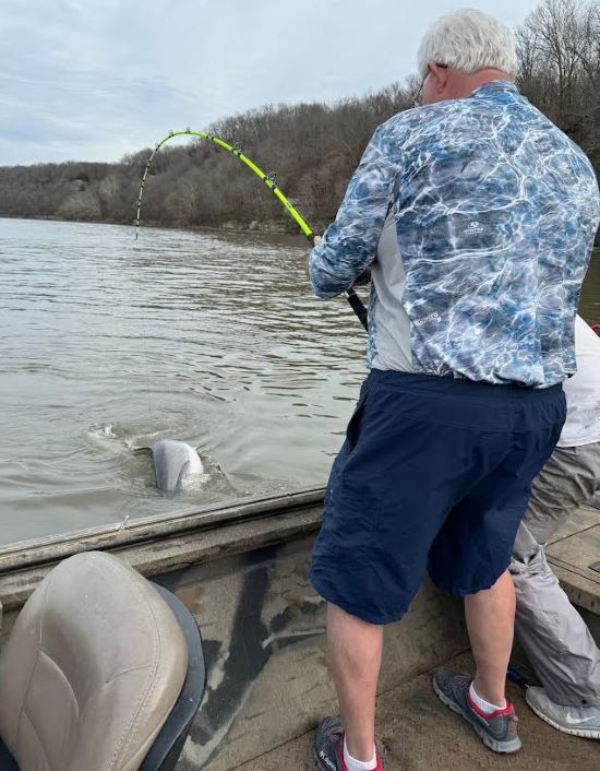 Greg Thompson fights a paddlefish he snagged at Grand Lake in Oklahoma.