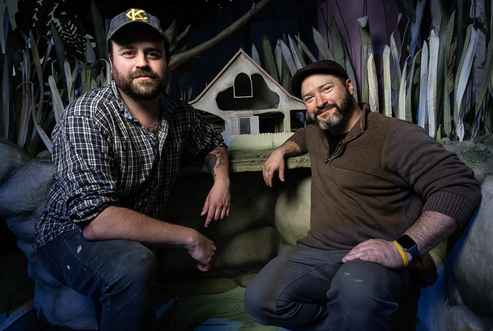 Artists and fabricators Evan Stein, left, and Grant Kelso next to Toad’s house, amidst the rocks and cattails from the "Frog and Toad" exhibit at The Rabbit Hole in North Kansas City.