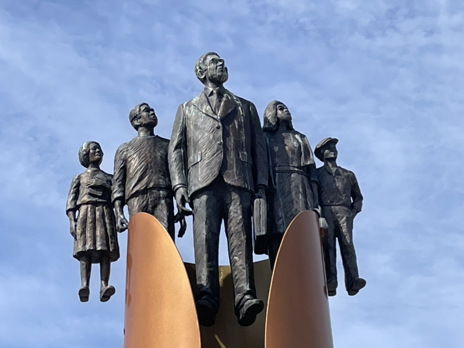 Bronze statue of five people of various ages all looking skyward.