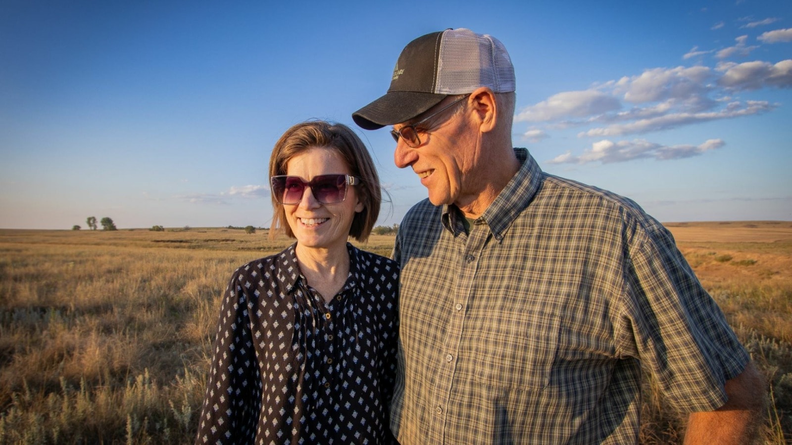 Bruce and Michelle Graham stand together in their Kansas pasture.
