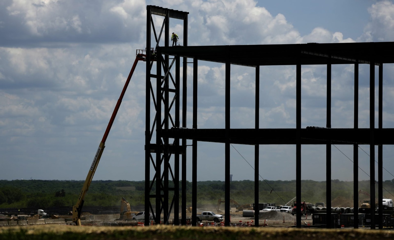 Ironworkers construct the framework of a $4 billion Panasonic EV battery plant on Thursday, May 18, 2023, near DeSoto, Kansas.