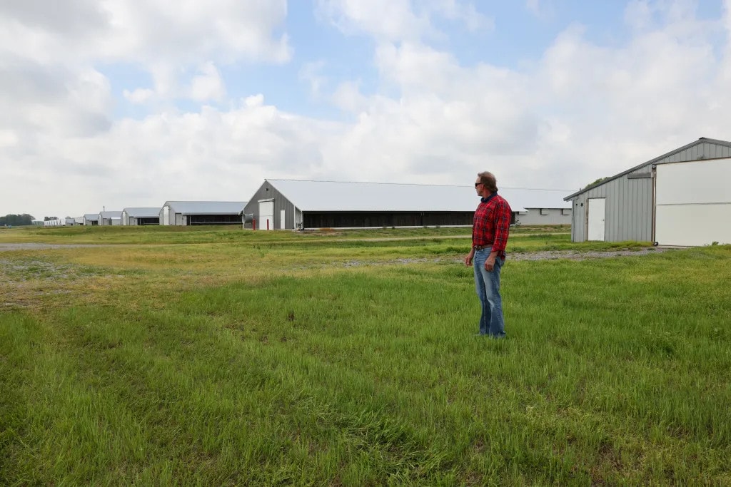 Preston Arnold in front of his chicken barns near Sikeston, Missouri.