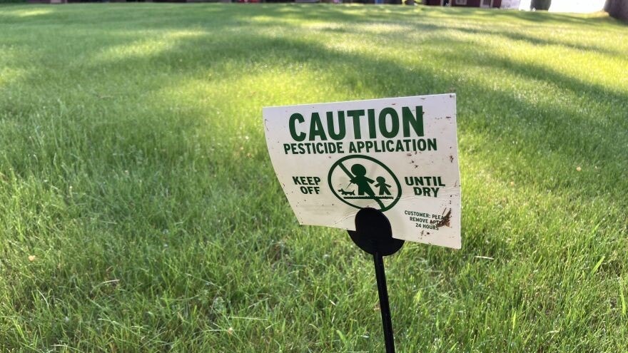 A sign warns of a recent pesticide application on a lawn in northern Michigan.