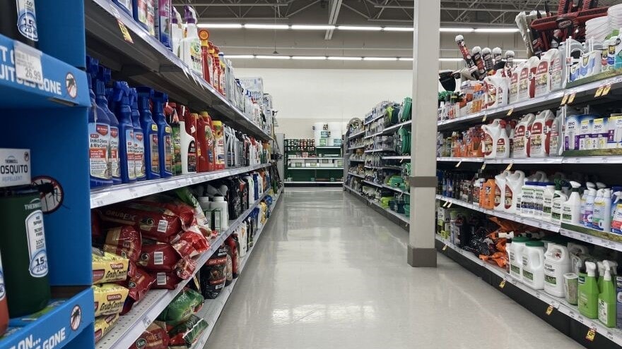 An aisle of lawn chemicals at a store.