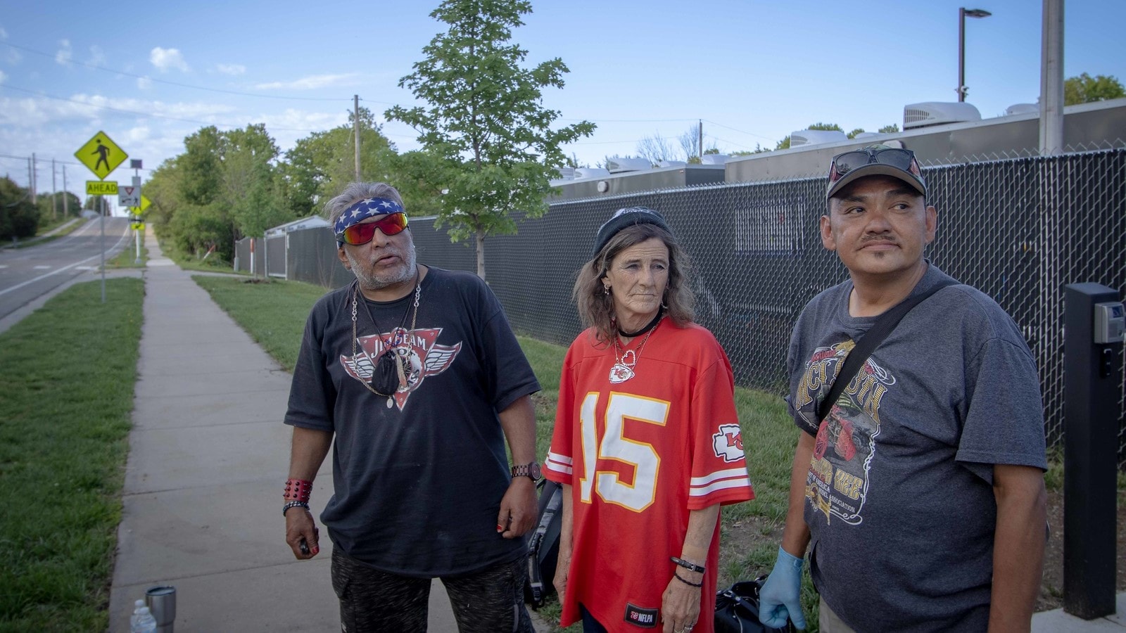 Pallet Shelter Village residents Luie Herrera, Rosetta Brackett, and Dale Tilden stand outside of the village.